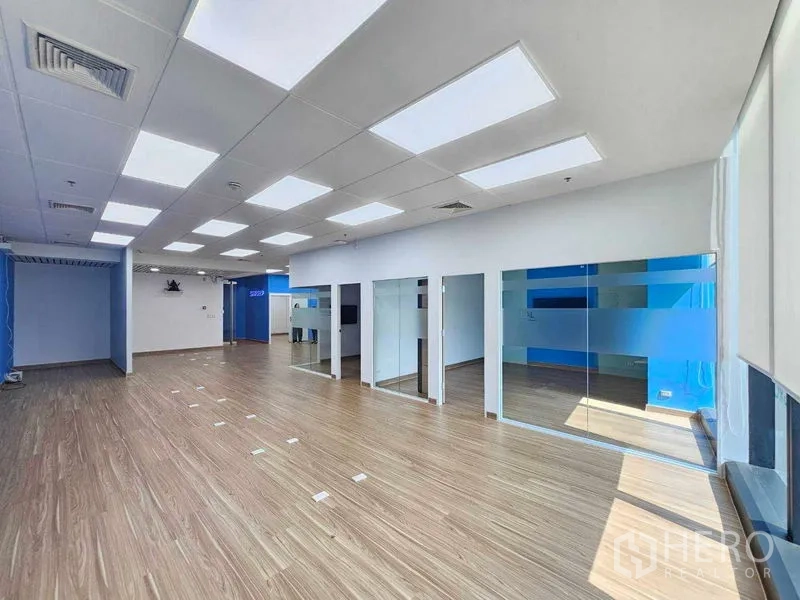 Office Space for rent in Sathon, Bangkok - Bright open office with multiple glass rooms and large windows.