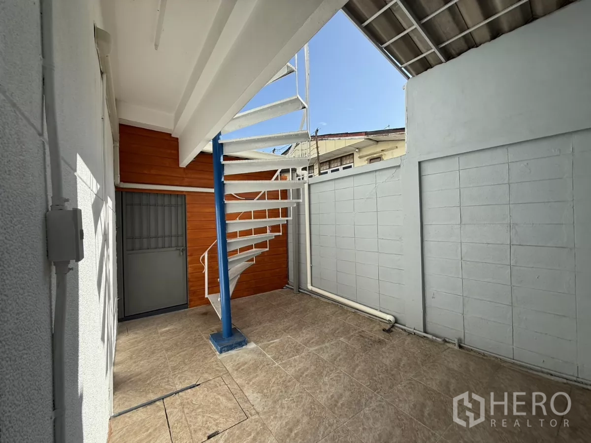 Office Space for rent in Wang Thonglang, Bangkok - Small outdoor terrace with spiral staircase and tiled flooring.