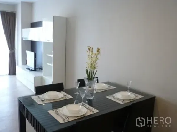 公寓 出租在Watthana, Bangkok - 四人玻璃餐桌，采光充足的起居空间。