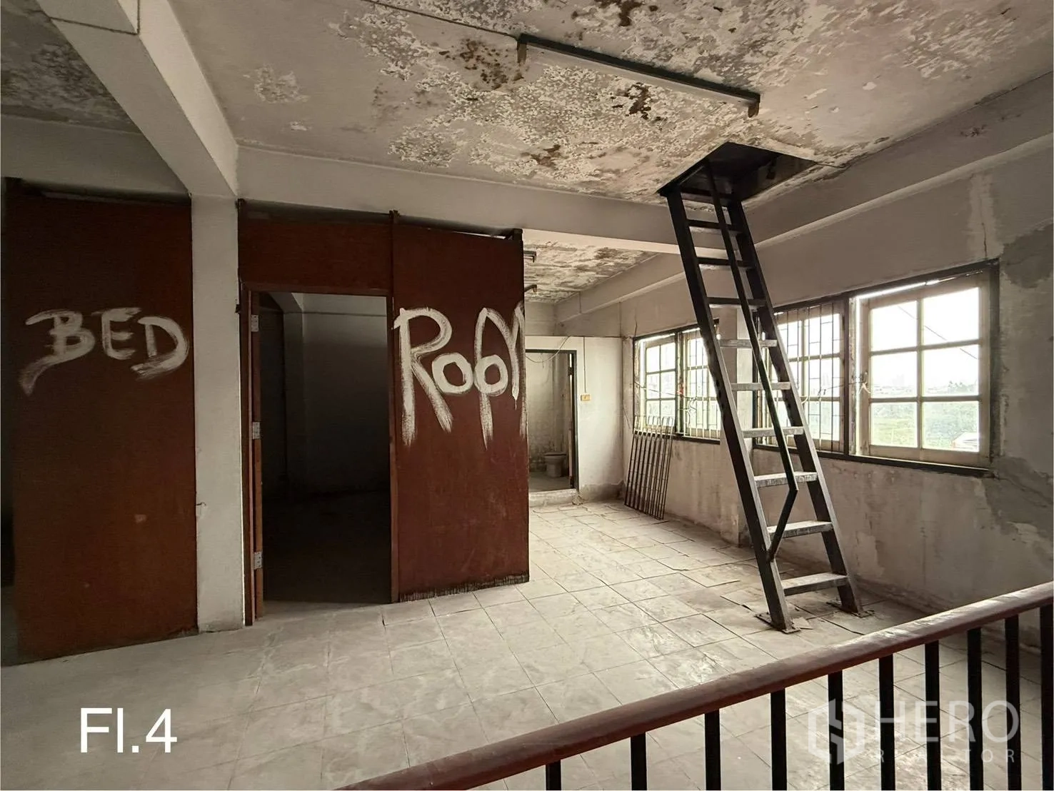 Shophouse for rent in Bang Na, Bangkok - Fourth-floor hall with ladder access to rooftop, windows and partitioned rooms.