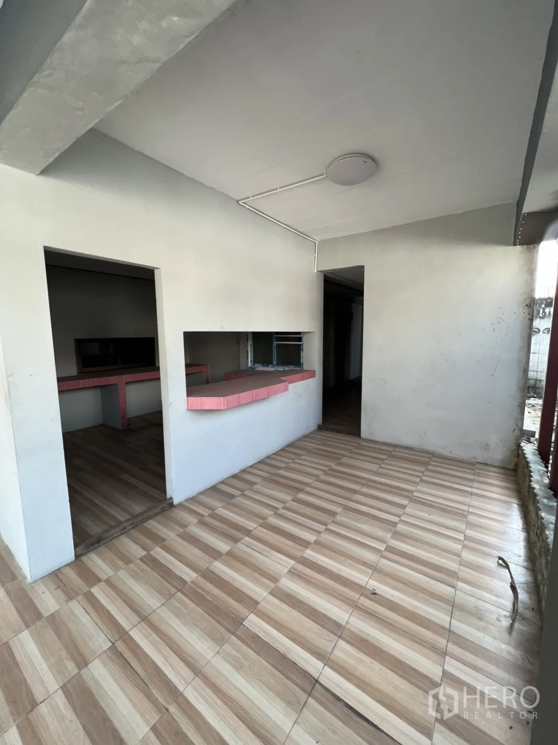 Home Office for rent in Watthana, Bangkok - Covered entry area with a service window and striped tile flooring.