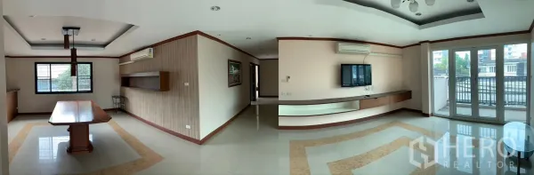 Home Office for rent - Panoramic office-living area with TV wall, ceiling lighting and balcony access overlooking the neighborhood.