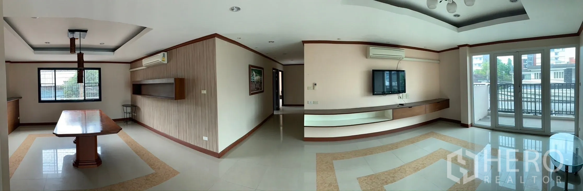 Home Office for rent - Panoramic office-living area with TV wall, ceiling lighting and balcony access overlooking the neighborhood.