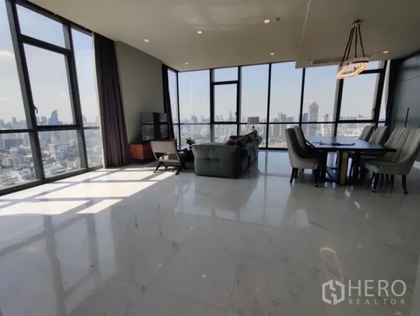 Condominium for rent in Watthana, Bangkok - Open-plan lounge and dining area with expansive windows and bright natural light facing the city.