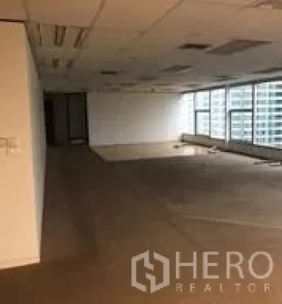 Office Space for rent in Bang Rak, Bangkok - Corner office area with panoramic windows overlooking high-rise buildings in the CBD.