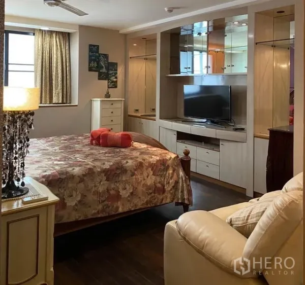 คอนโด ให้เช่าในKhlong Toei, Bangkok - ห้องนอนมาสเตอร์พร้อมผ้าปูดอกไม้ ตู้บิลท์อิน และชั้นวางทีวี ที่คอนโด President Park เขตคลองเตย กรุงเทพฯ