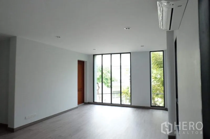 Detached House for sale in Bang Phli, Samut Prakan - Upper-floor room with floor-to-ceiling windows and air conditioning.