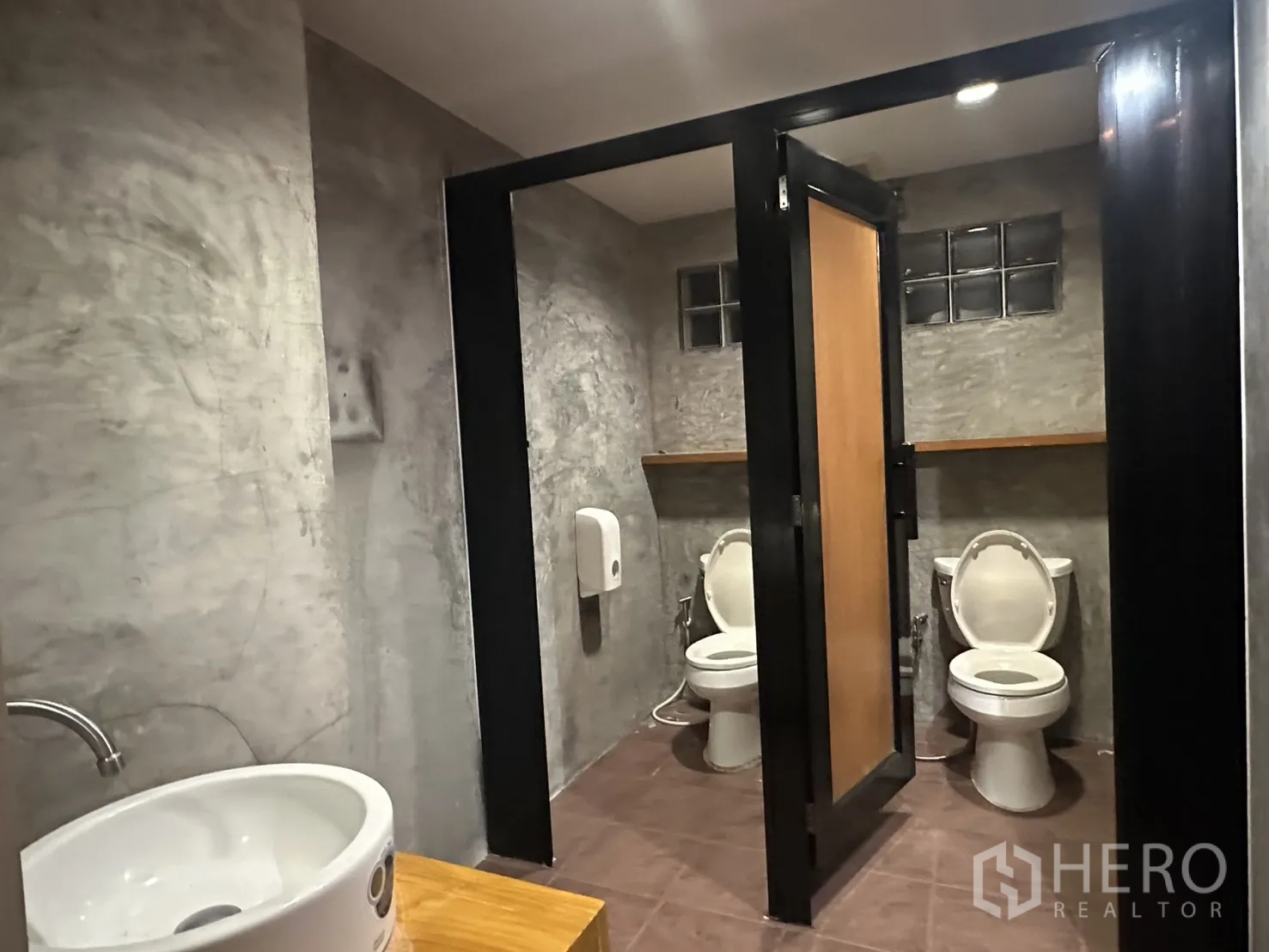 Retail Space for rent in Watthana, Bangkok - Industrial-style washroom with separate toilet stalls and a countertop basin.