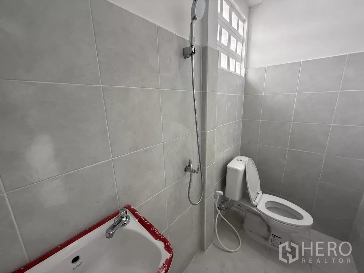 Warehouse for rent in Lat Krabang, Bangkok - New tiled restroom with shower, toilet and ventilated glass block window.