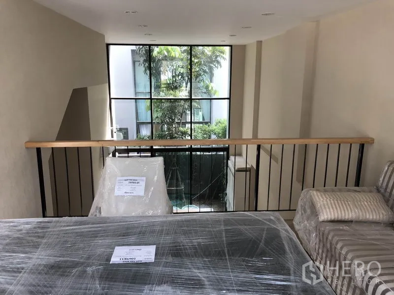 Townhouse for rent in Suan Luang, Bangkok - View from the mezzanine toward the large window and garden outside.