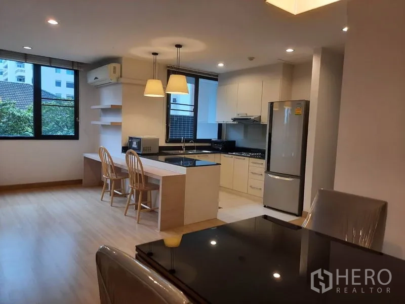 คอนโด ให้เช่าในWatthana, Bangkok - ครัวบิวท์อินตู้สีขาว เคาน์เตอร์ไอส์แลนด์ โคมไฟแขวน ตู้เย็นสแตนเลส ติดกับโซนรับประทานอาหาร