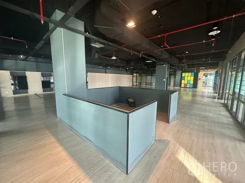 Office Space for rent in Bang Rak, Bangkok - Reception or collaboration island at the center of an expansive office with exposed ductwork.