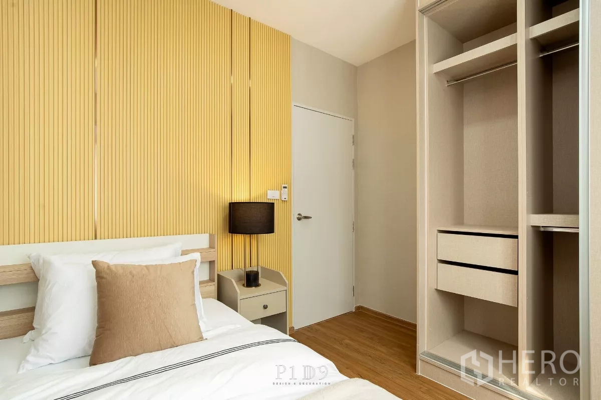 Townhouse for rent in Bang Phli, Samut Prakan - Third bedroom with open wardrobe, shelving and warm wood floor