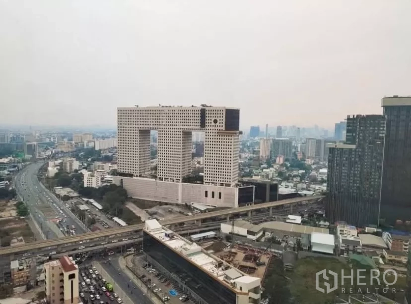 Condominium for rent in Chatuchak, Bangkok - High-floor view of the Ratchadaphisek corridor featuring the iconic Elephant Building and BTS line.