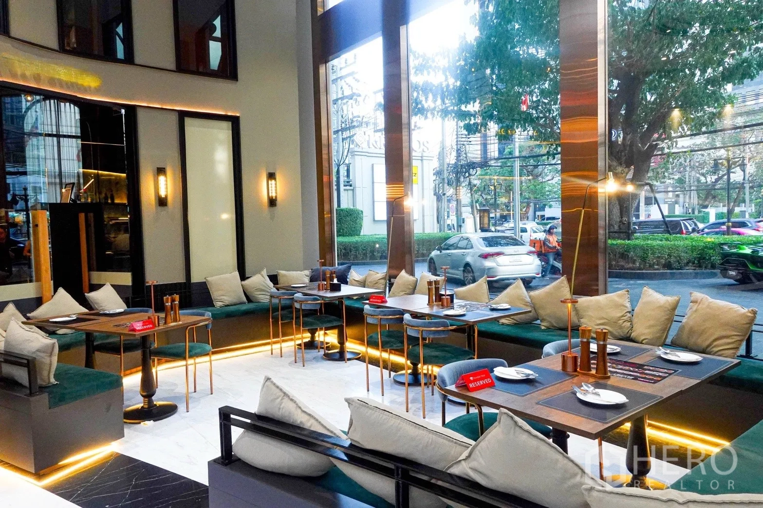 Retail Space for rent in Bang Rak, Bangkok - Street-facing dining space with large windows, banquette seating, and modern tables.