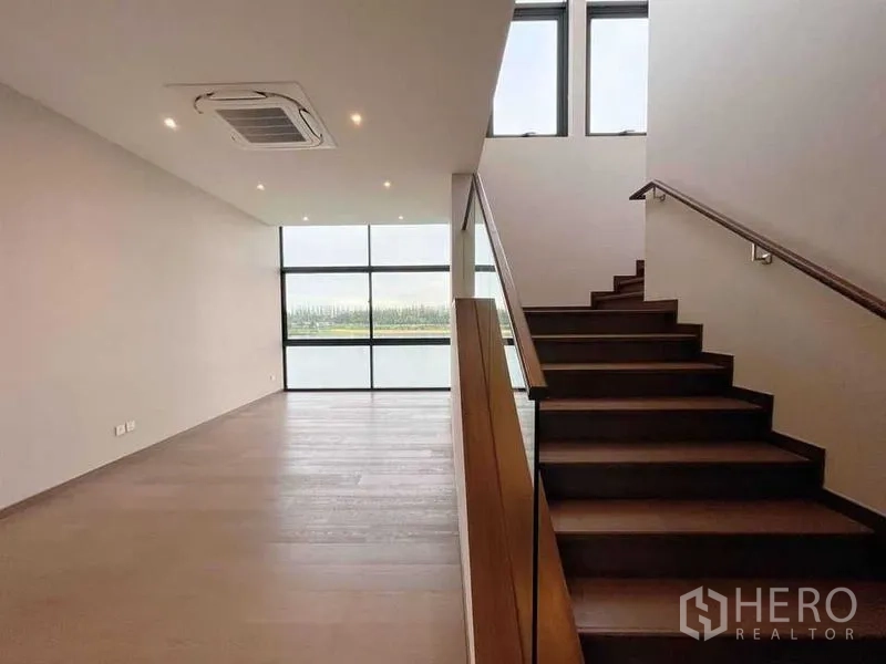 Detached House for sale in Bang Phli, Samut Prakan - Stair hall with wooden steps and expansive lake-view windows.