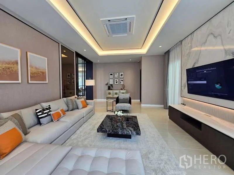 บ้าน ให้เช่าหรือขายในLat Krabang, Bangkok - ห้องนั่งเล่นครอบครัว ไฟฝ้าซ่อนไฟ ผนังทีวี และโต๊ะกลางหินอ่อน