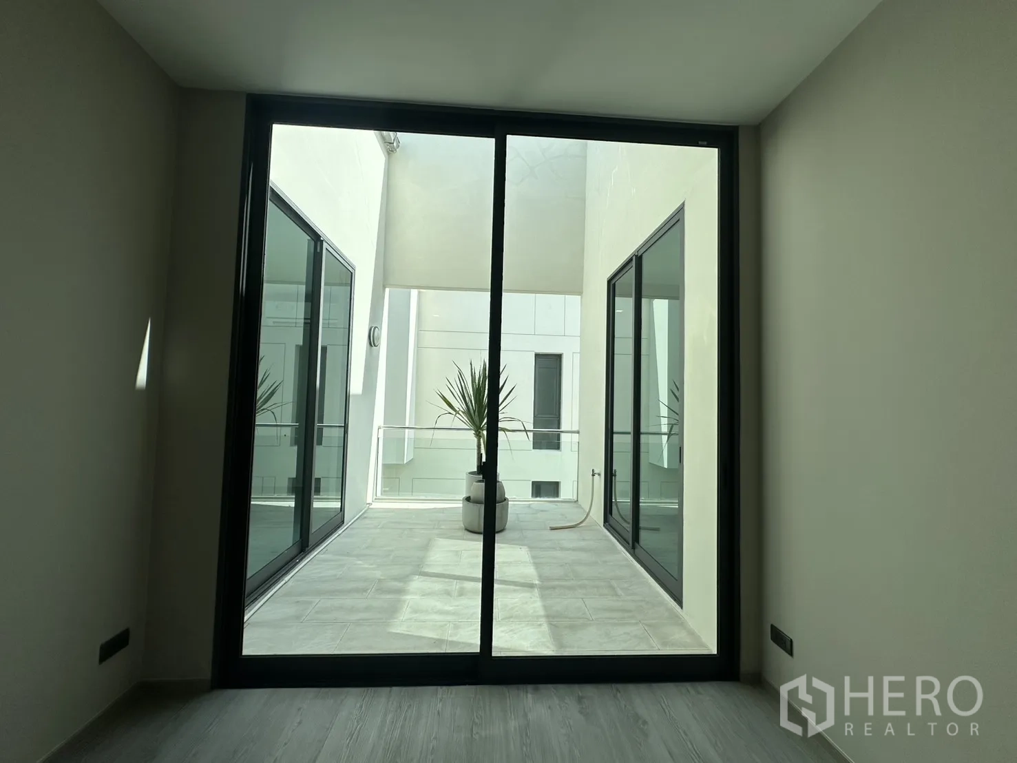 Home Office for rent or sale in Suan Luang, Bangkok - Small room opening to an open-air terrace with planters.
