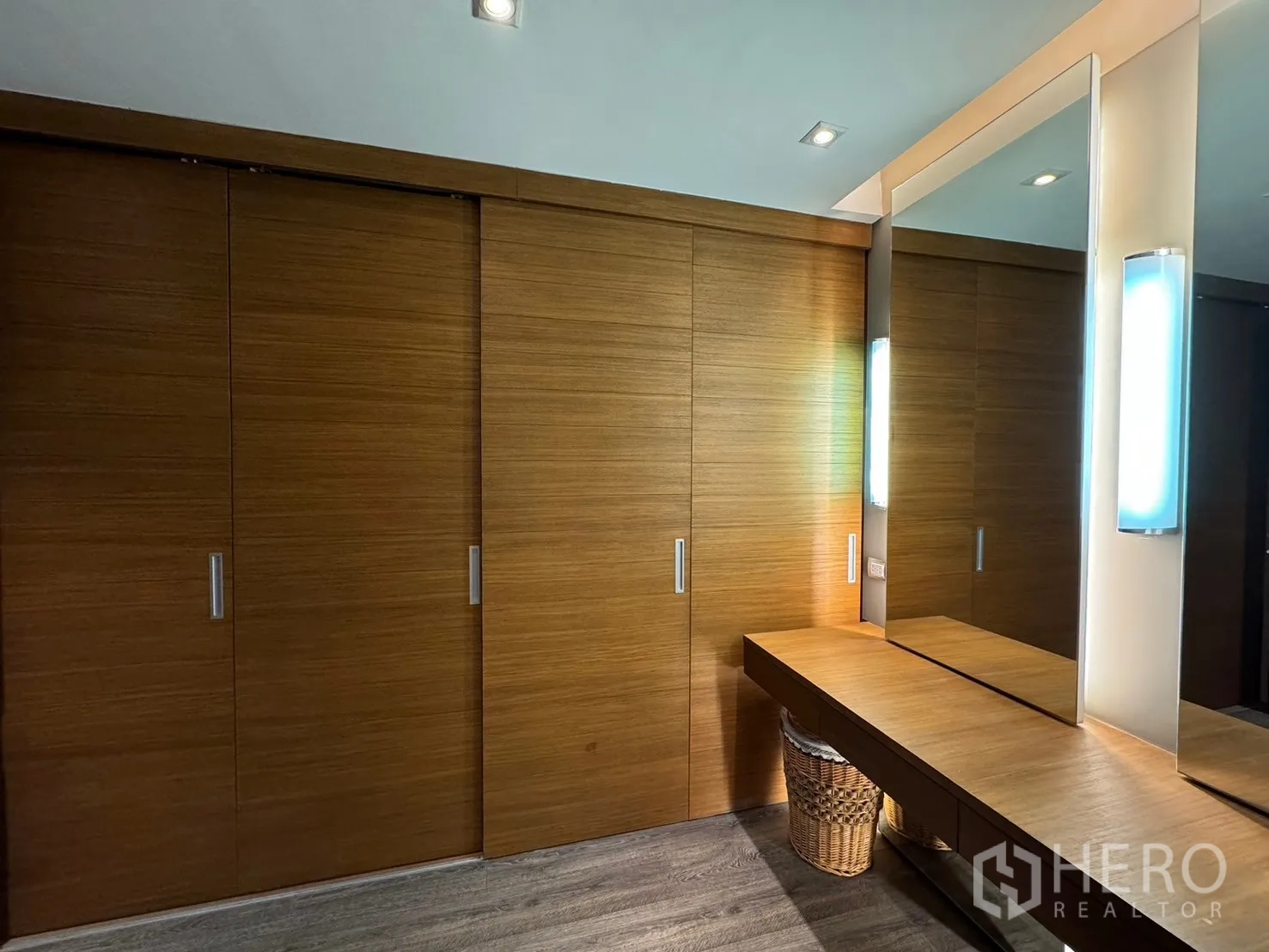 Condominium for rent - Walk-in closet and vanity with full-height mirror and wood cabinetry.