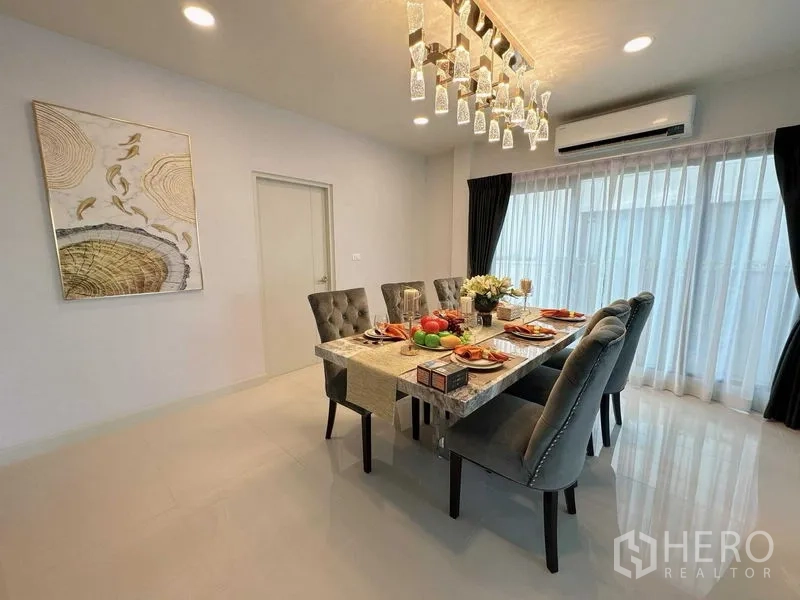 Detached House for rent or sale - Spacious dining area with marble table, gray chairs, air conditioner and floor-to-ceiling curtains.