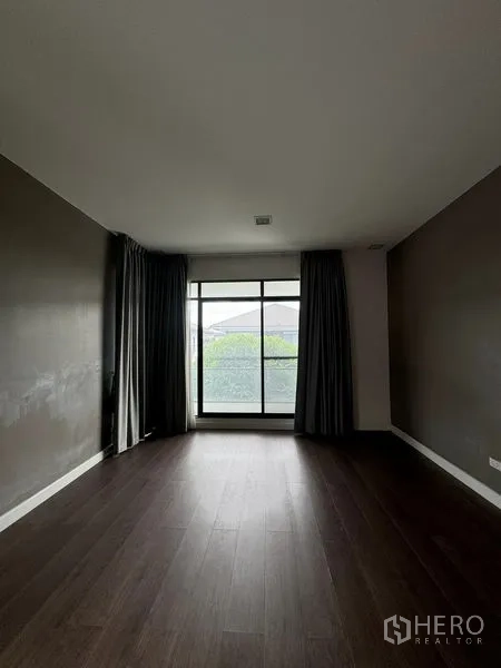 Detached House for rent in Samut Prakan - Bedroom with dark feature walls, big window and blackout drapes.