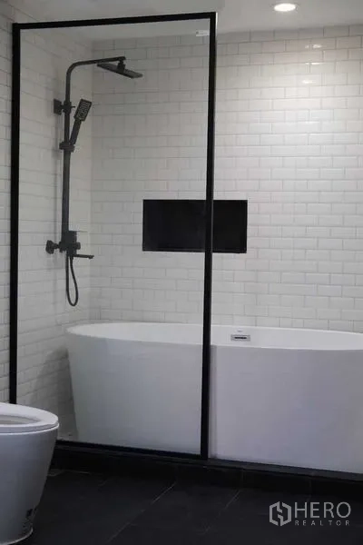 公寓 出租在Bang Rak, Bangkok - 浴室，独立浴缸、步入式淋浴间与地铁砖墙。
