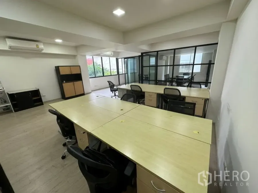 Office Space for rent in Khlong Toei, Bangkok - Open-plan workspace with bench desks, glass-partitioned rooms, and air-conditioning.