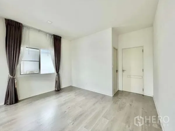 บ้าน ให้เช่าในPrawet, Bangkok - ห้องเปล่ามีหน้าต่าง ผ้าม่านสีน้ำตาล ประตูสีขาว และพื้นลามิเนตไม้.