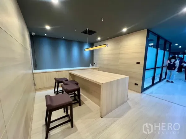 Office Space for rent in Watthana, Bangkok - Breakout pantry with light wood island, stools and pendant lighting.