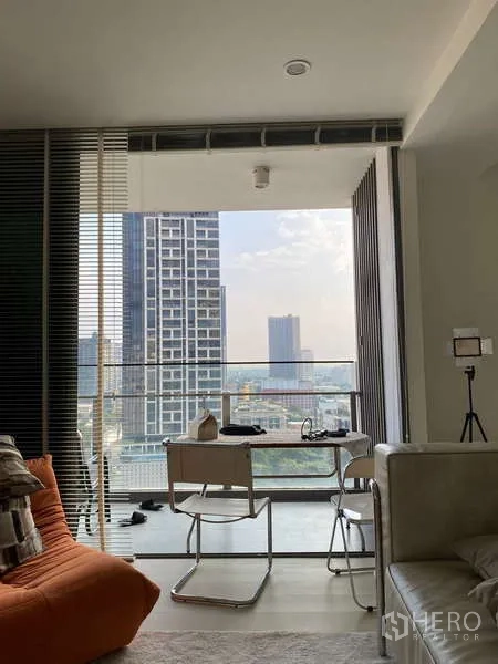 Condominium for rent - Living area leading to the balcony with skyline view through sliding doors.