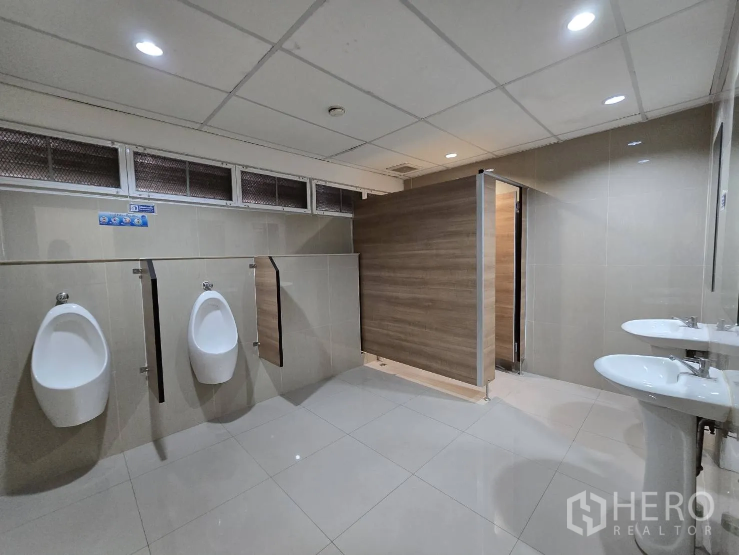 Retail Space for rent in Watthana, Bangkok - Men’s restroom with urinals, stalls, and twin pedestal sinks in tiled finish.