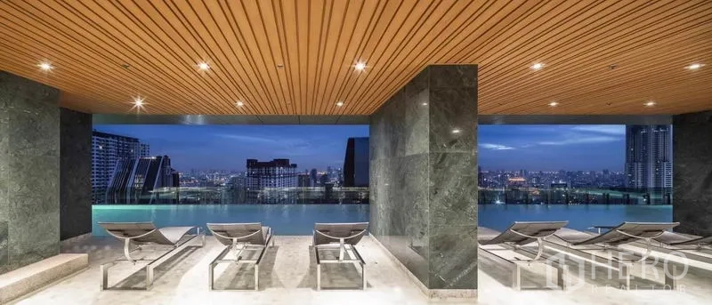Condominium for rent or sale in Ratchathewi, Bangkok - Covered pool deck with sun loungers overlooking the city and an infinity-edge pool.