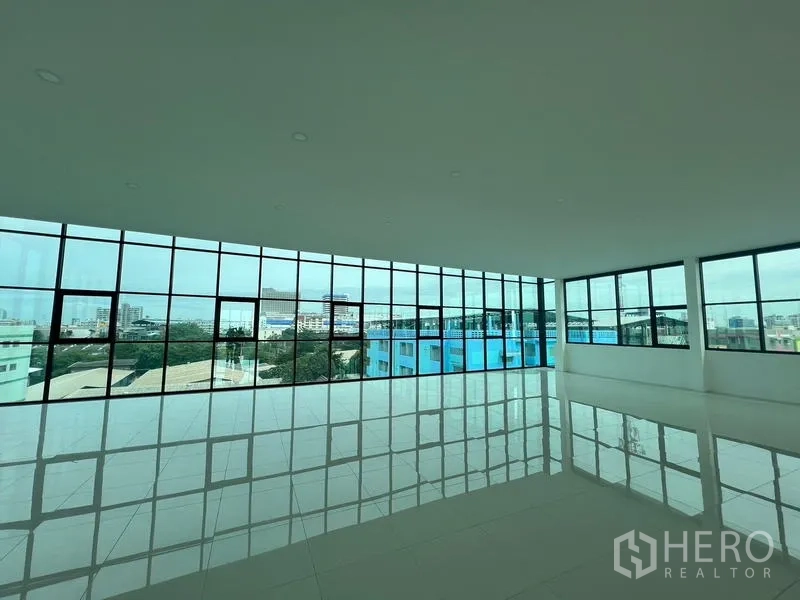 Office Space for rent or sale in Wang Thonglang, Bangkok - Top floor office with wraparound glazing and skyline views.