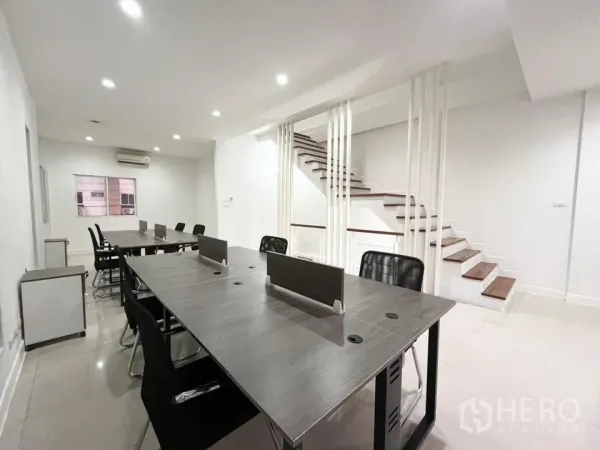 Home Office for rent in Bueng Kum, Bangkok - Work zone with long desks beside decorative vertical slats and wooden stairs