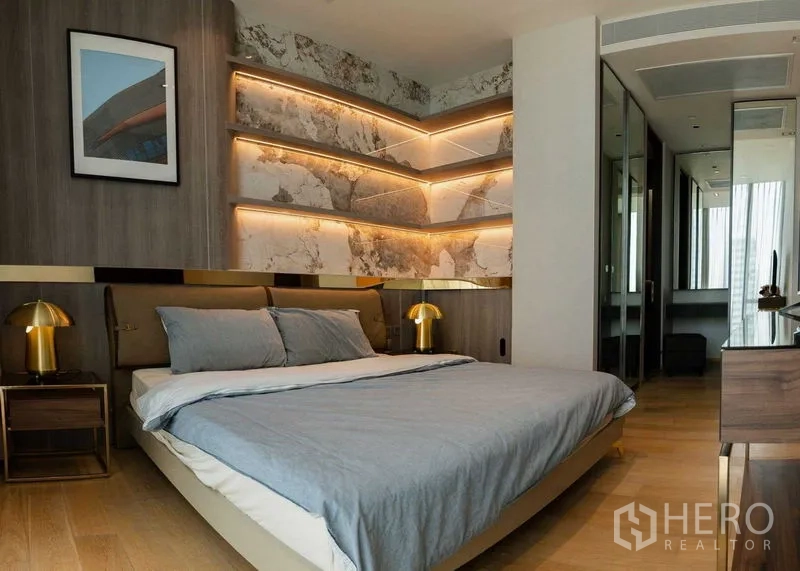 Condominium for rent - Primary bedroom featuring backlit marble shelves, bedside lamps and wood flooring.