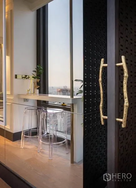 Condominium for rent in Bang Rak, Bangkok - Window bar with clear stools and brass handles offering a wide city panorama.