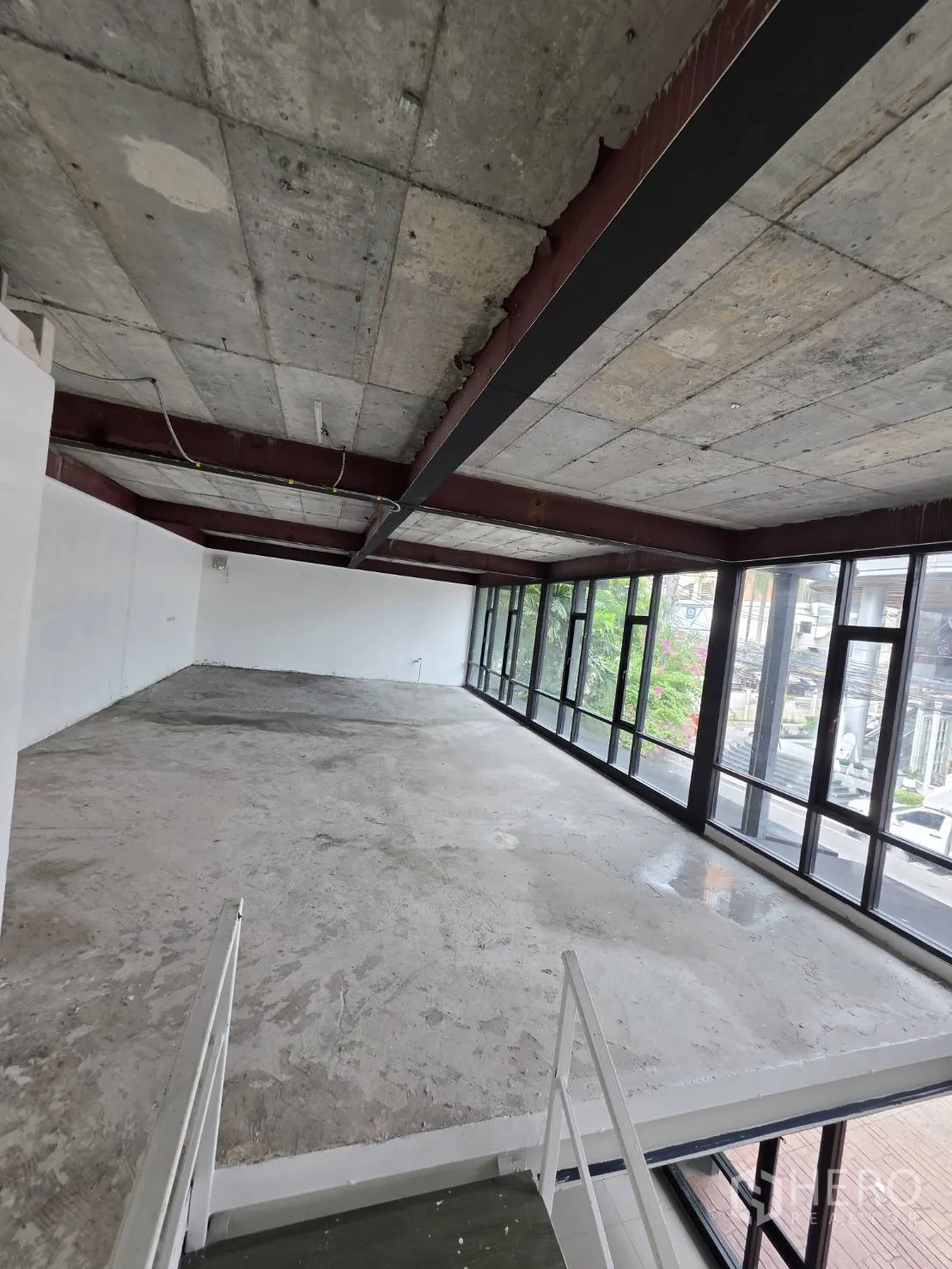 Retail Space for rent in Watthana, Bangkok - Open-plan mezzanine space with a long window wall and industrial concrete ceiling.