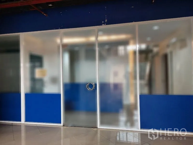 Retail Space for rent in Sathon, Bangkok - Glass-front shop facade with frosted panels and circular pull handle.