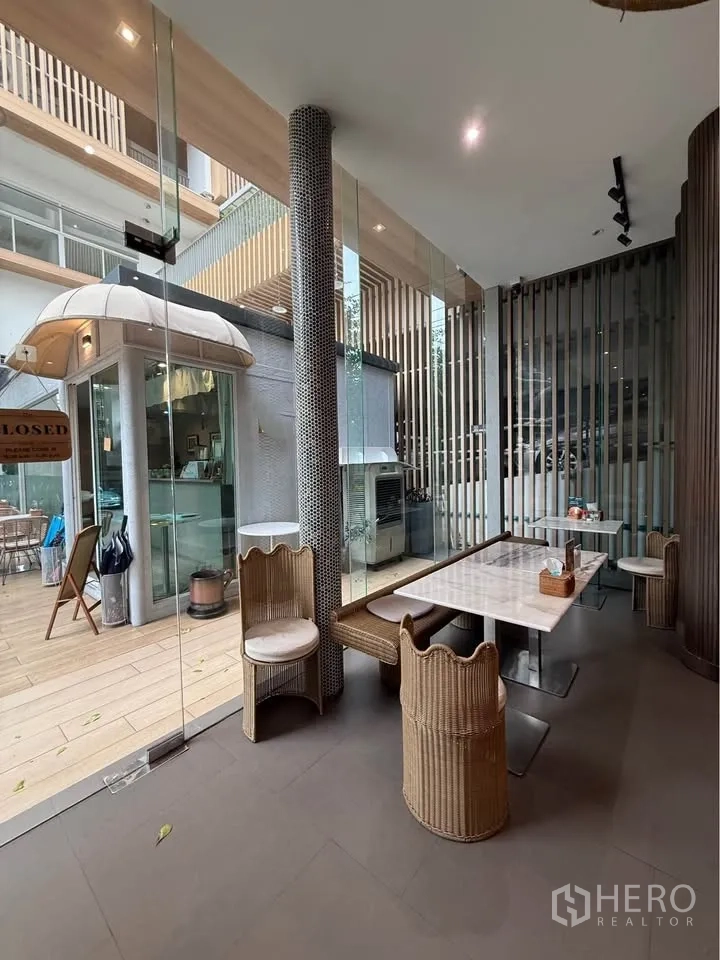 Retail Space for rent in Watthana, Bangkok - Glass-enclosed seating area with rattan chairs opening to the patio.
