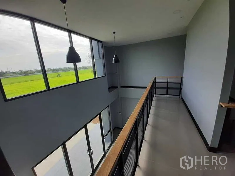 工厂 出租或出售 - 二层走道，吊灯与大窗户，可眺望田景。