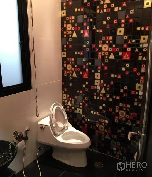 Detached House for rent in Khlong Toei, Bangkok - Bathroom with patterned mosaic feature wall, toilet and glass bowl sink.