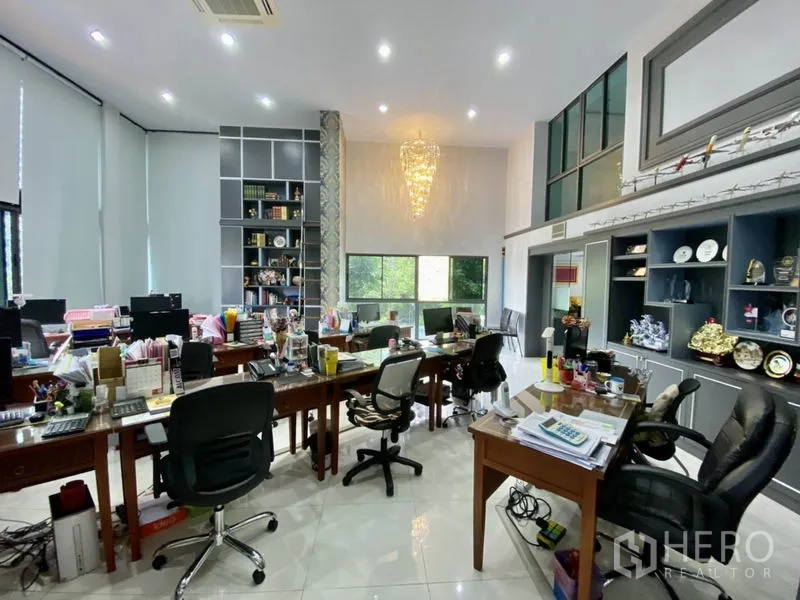 Home Office for rent or sale in Yan Nawa, Bangkok - Bright office workspace with chandelier, large windows, and display shelves.