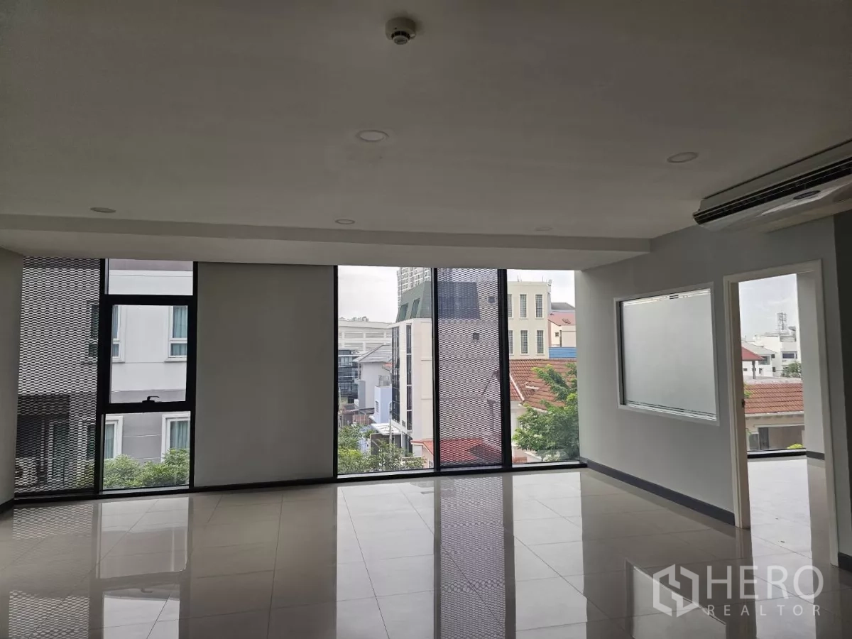 Office Space for rent in Sathon, Bangkok - Open office space with partial glass partition and access to an adjoining room or meeting area.