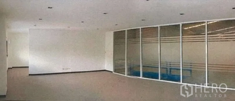 Warehouse for rent in Phra Pradaeng, Samut Prakan - Bright office room with glass-partitioned meeting area inside an industrial building.