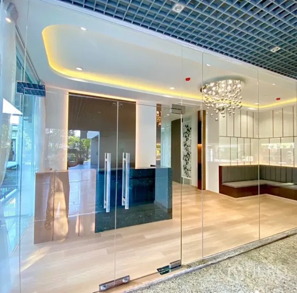 Office Space for rent - Glass-fronted office entrance with chandelier, reception desk and built-in bench.