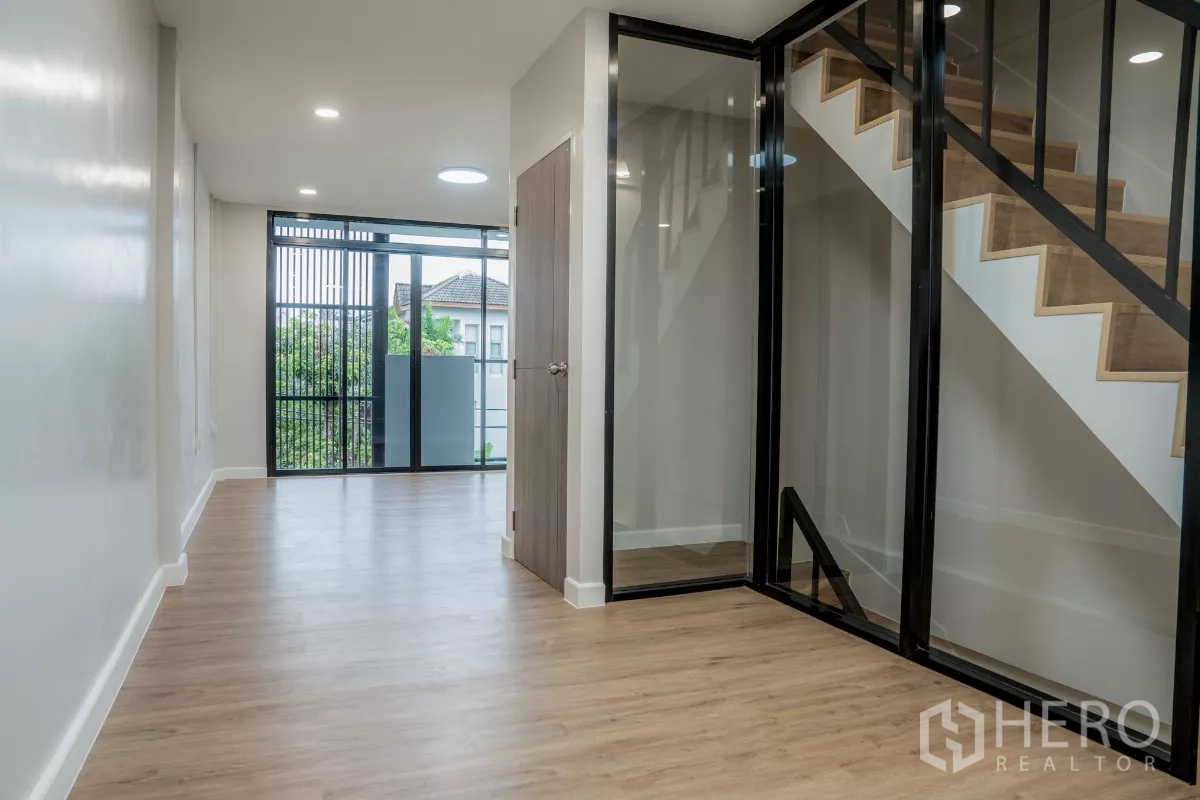 ทาวน์เฮาส์ ขายในWatthana, Bangkok - พื้นที่พักผ่อนชั้นบน กั้นบันไดด้วยกระจก และประตูกระจกบานเลื่อนเปิดสู่ระเบียง