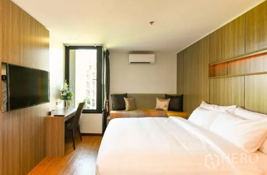 อาคารพาณิชย์ ให้เช่าในWatthana, Bangkok - ห้องสมัยใหม่สว่างด้วยงานไม้บิลต์อิน ทีวีติดผนัง โต๊ะทำงานริมหน้าต่าง มุมโซฟา และเครื่องปรับอากาศ