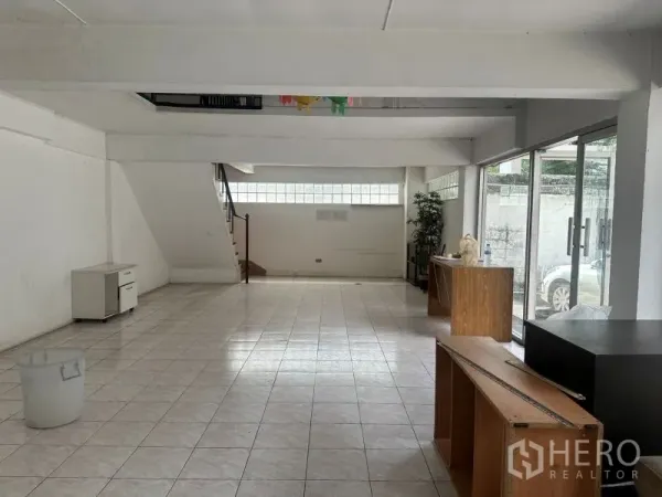 Office Space for rent - Spacious first-floor area with staircase and large windows to driveway