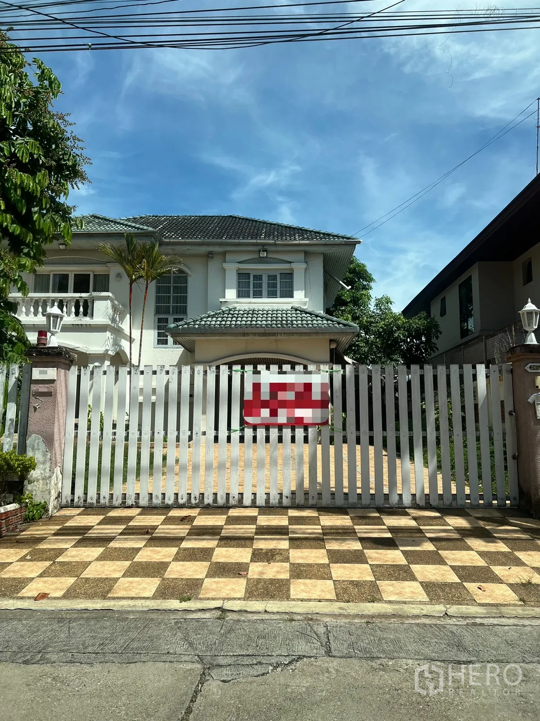Detached House for sale in Saphan Sung, Bangkok - Close-up of entrance gate and forecourt with checker tile pattern.