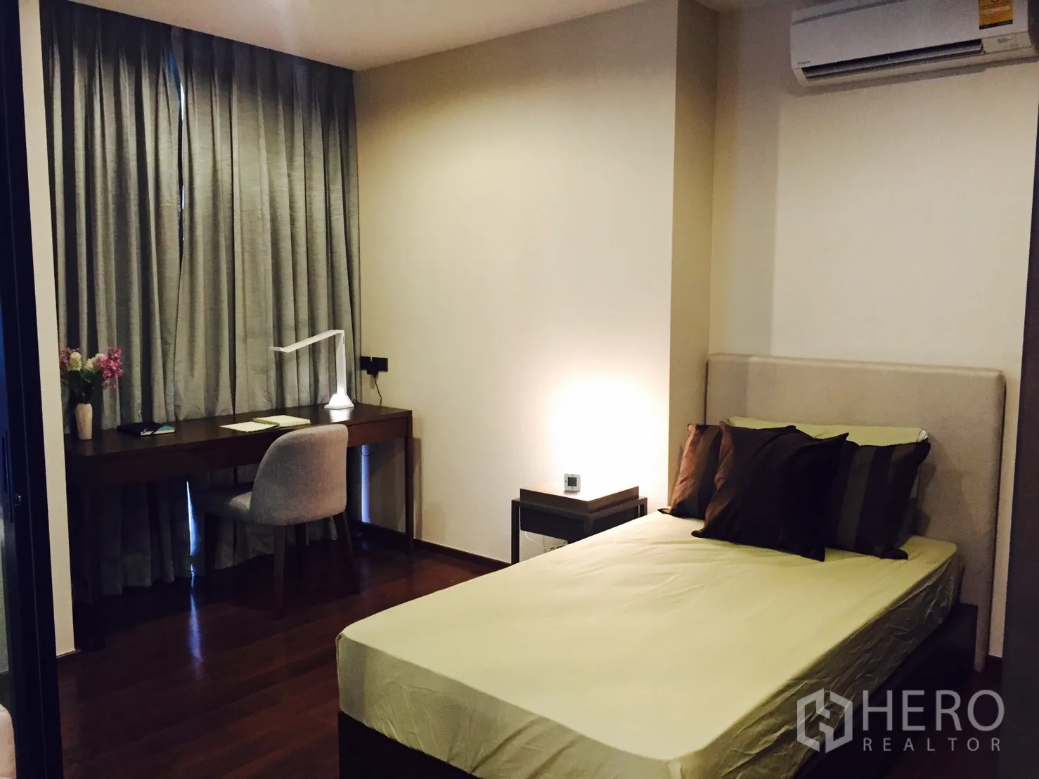 公寓 出租或出售在Sathon, Bangkok - 温馨卧室，配书桌与落地窗帘，灯光柔和，木地板。